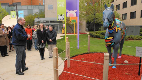 The Rev. Daniel Brandt, left, chaplain for the Chicago Police Department, blesses a statue in memory of 9-year-old Kira Mammoser